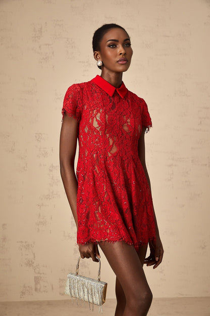A short red mini dress with sequins and lace detailing named Hanne