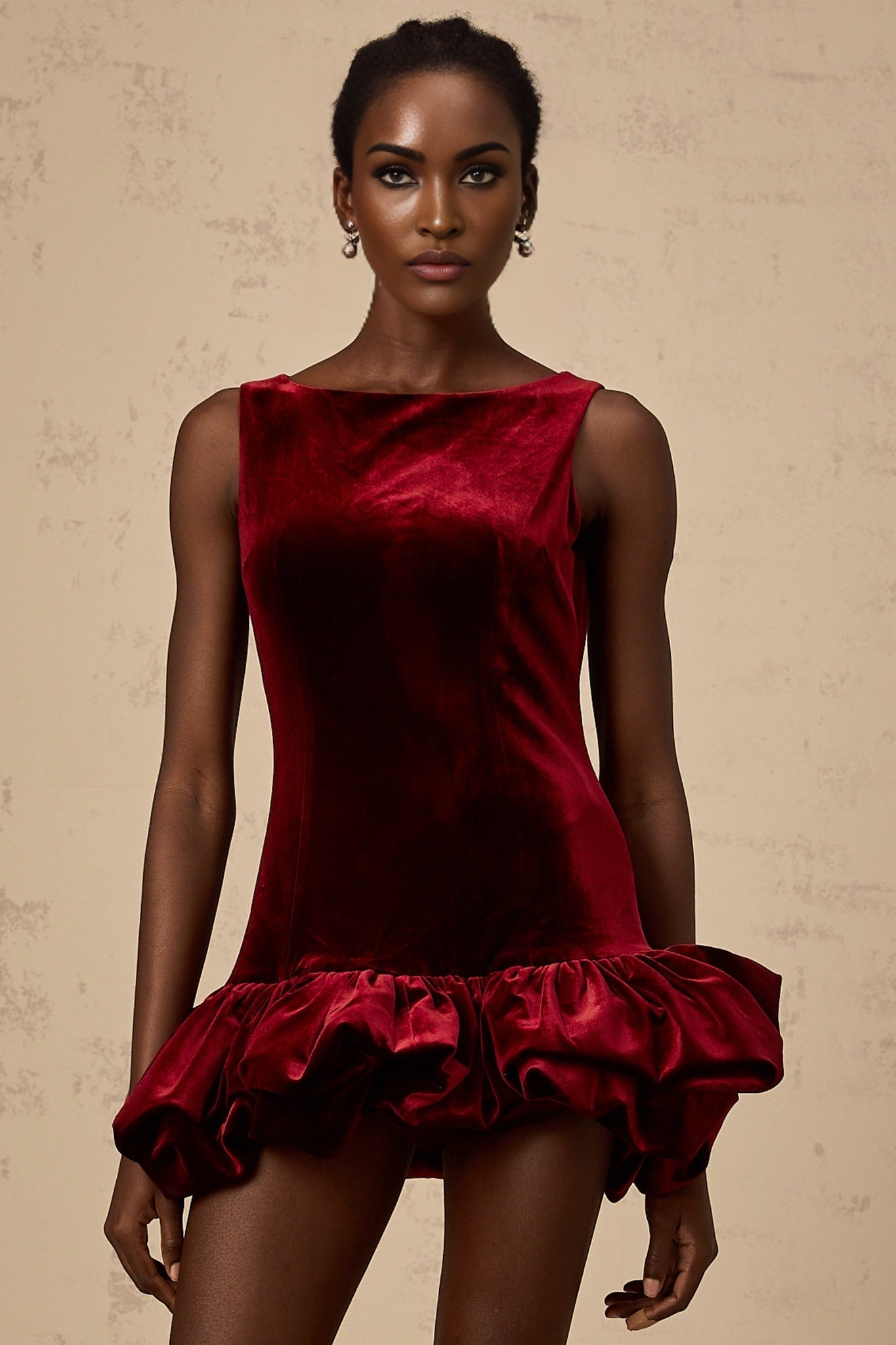 A short red velvet dress with a peplum hem detail and mini length perfect for evening wear