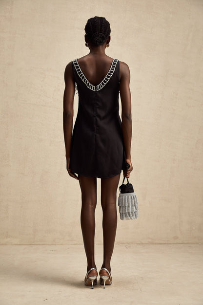 A short satin mini dress in a light color adorned with crystal embellishments elegant cocktail attire with a feminine silhouette