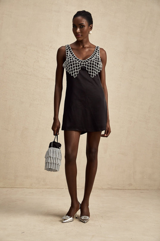 A short satin mini dress in a pale color adorned with crystal embellishments elegant cocktail attire with a feminine silhouette