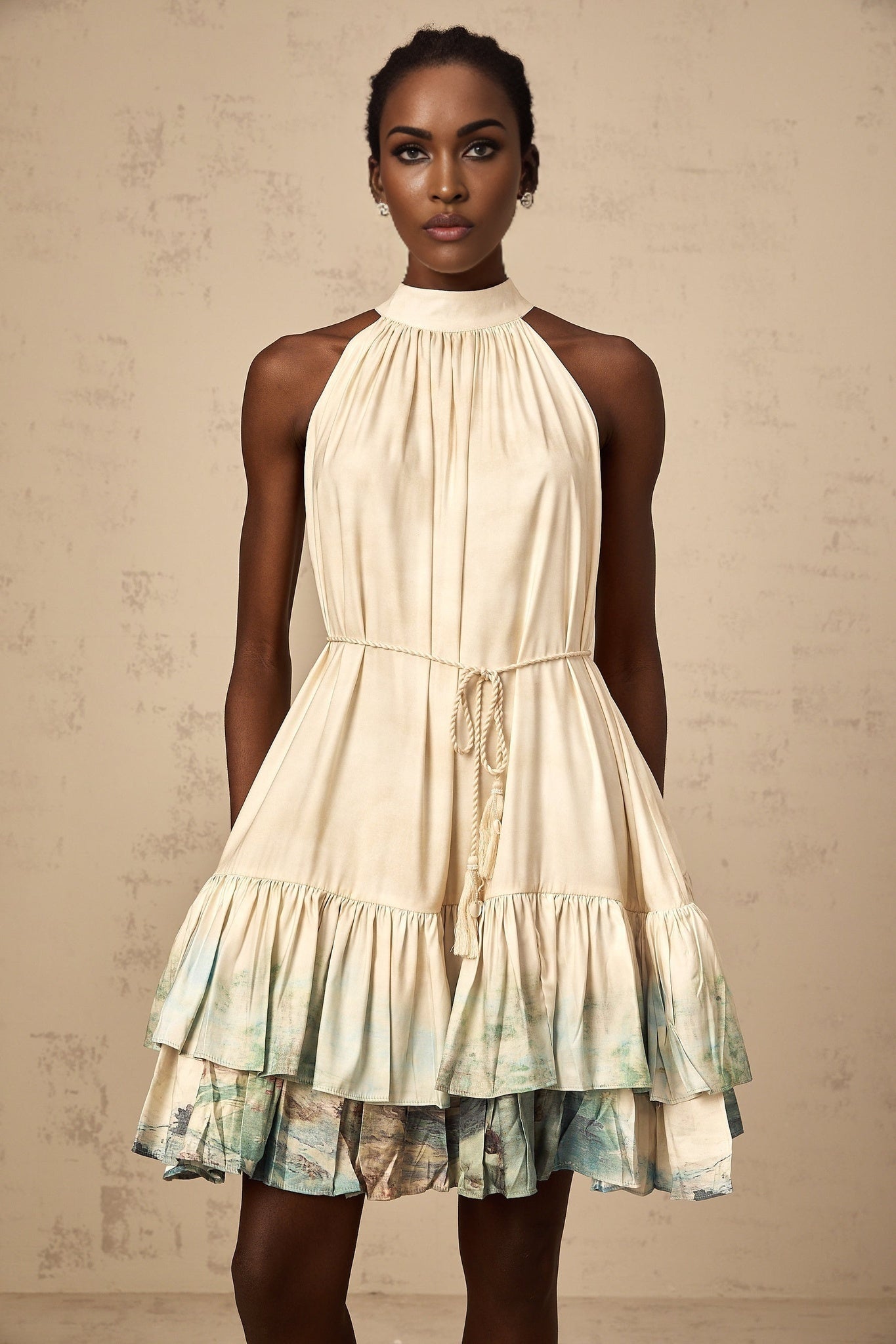 A short sleeveless mini dress with a layered design featuring a colorful pattern print named Delphine