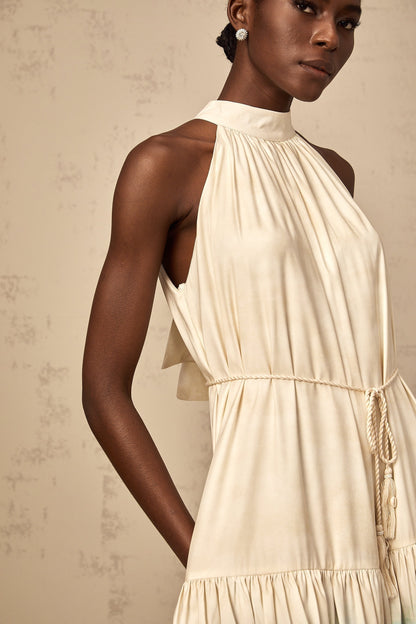 A short sleeveless mini dress with a layered design featuring a mix of floral and geometric patterns in multiple colors