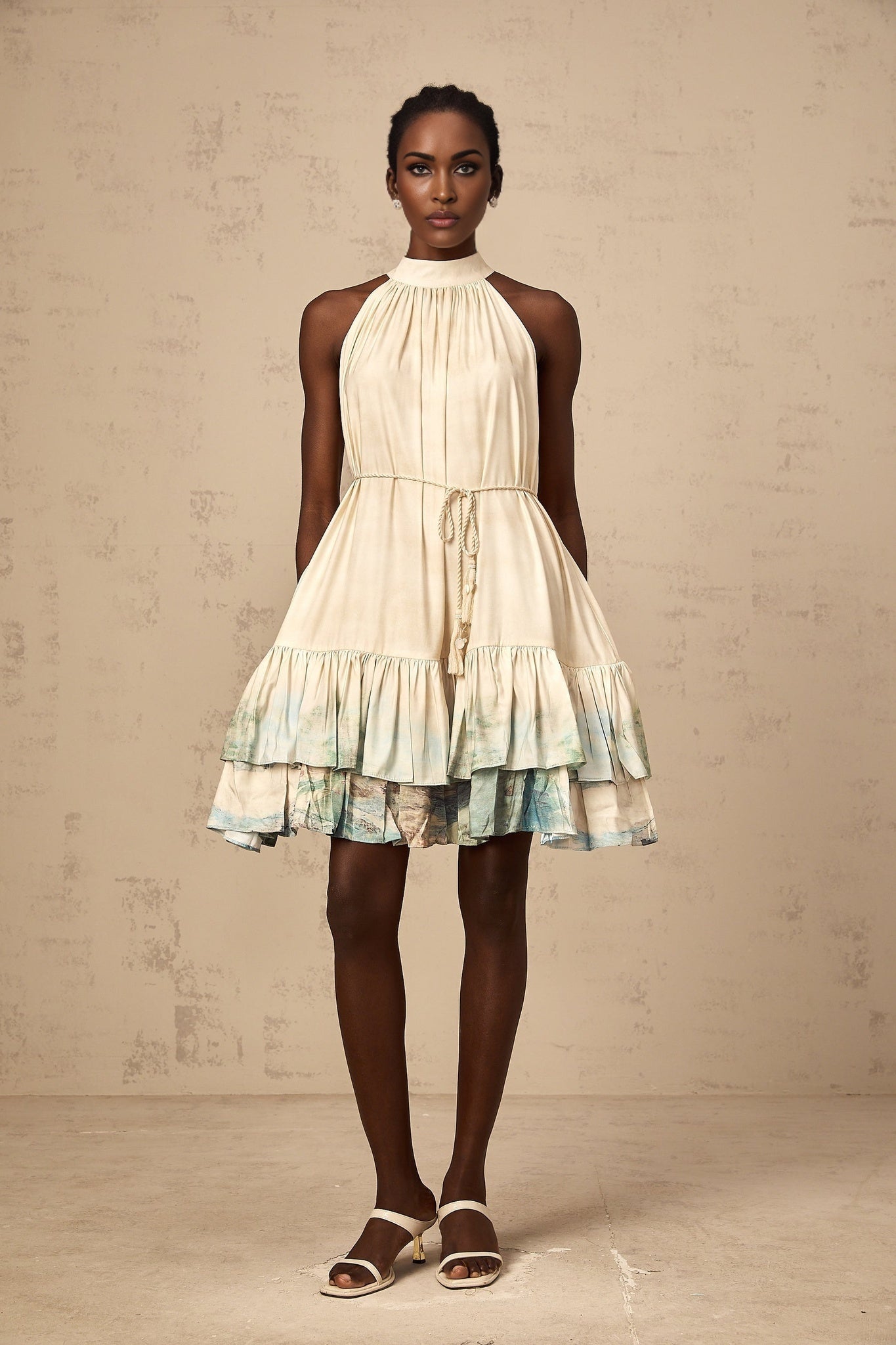 A short sleeveless mini dress with layered ruffles featuring a delicate floral pattern print in light colors