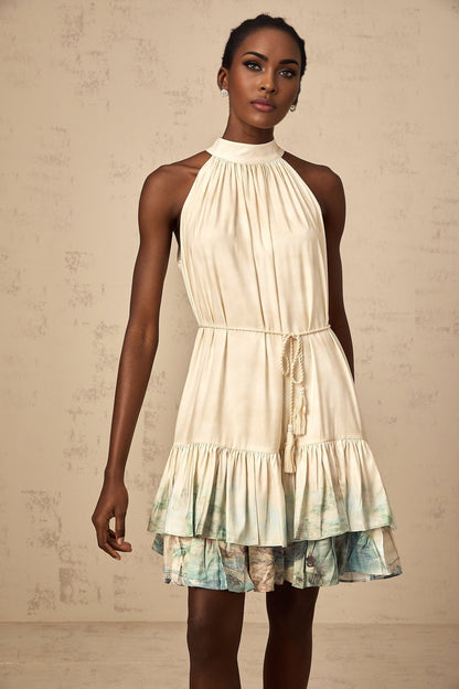 A short sleeveless mini dress with multiple layers featuring a mixed pattern print in various colors and designs