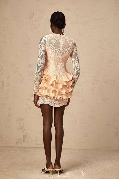 A short white dress with tiered ruffles and floral lace panels featuring a sleeveless design and a feminine silhouette