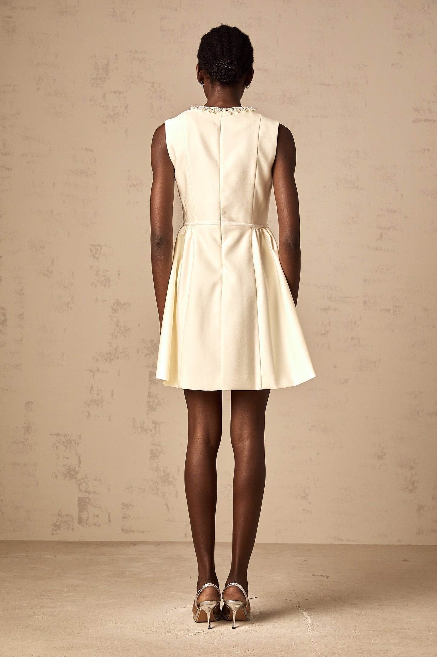 A short white mini dress with a bowknot embellishment named Isabelle