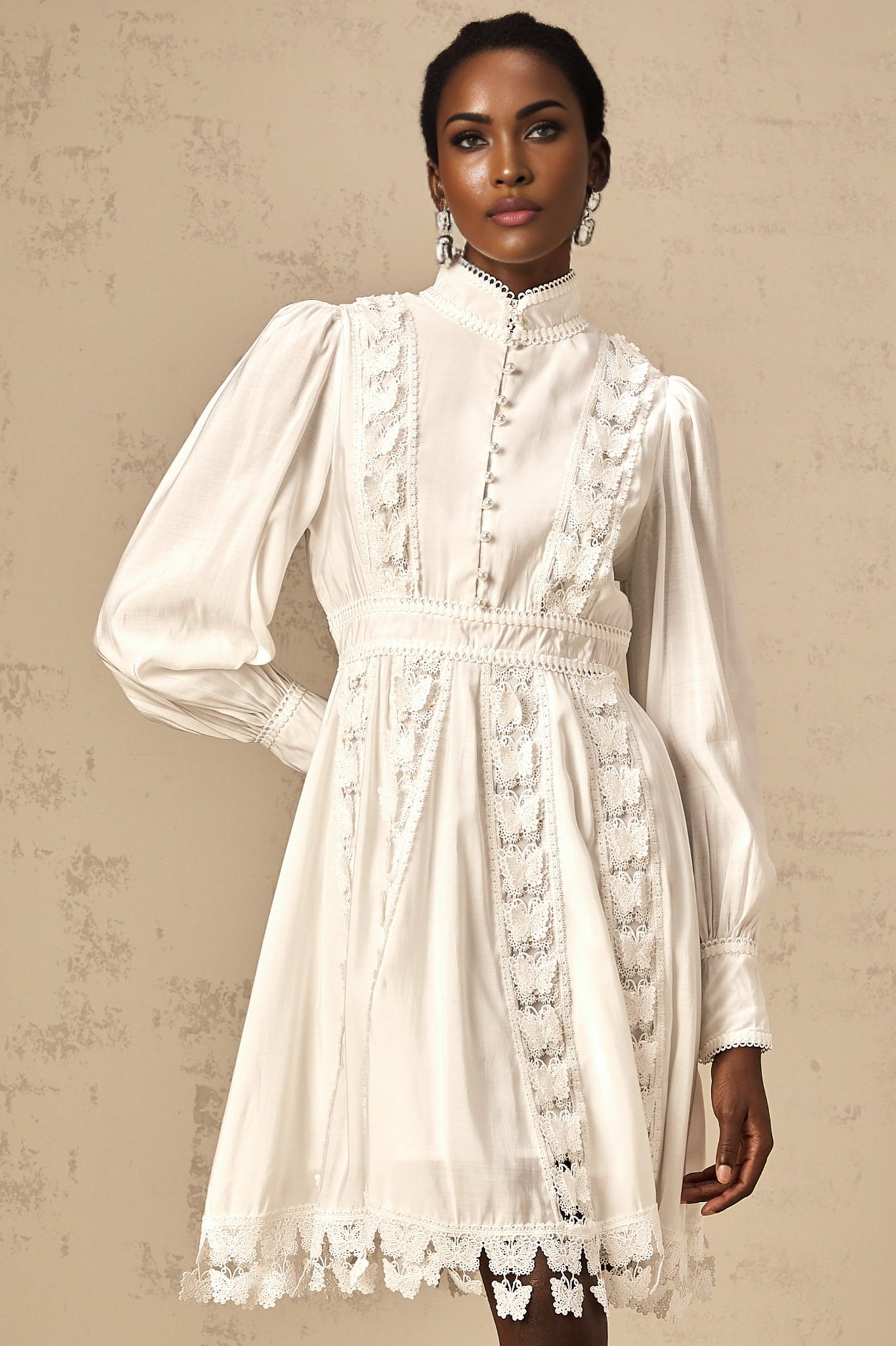 A short white mini dress with butterfly appliqués decorating the fabric