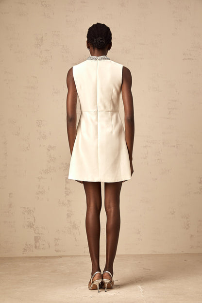 A short white mini dress with crystal embellishments adorning the fabric named Babette