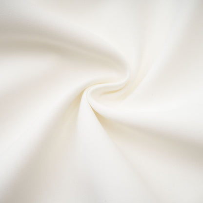 A short white mini dress with embellishments and detailing likely featuring a slim fit and decorative elements on the fabric