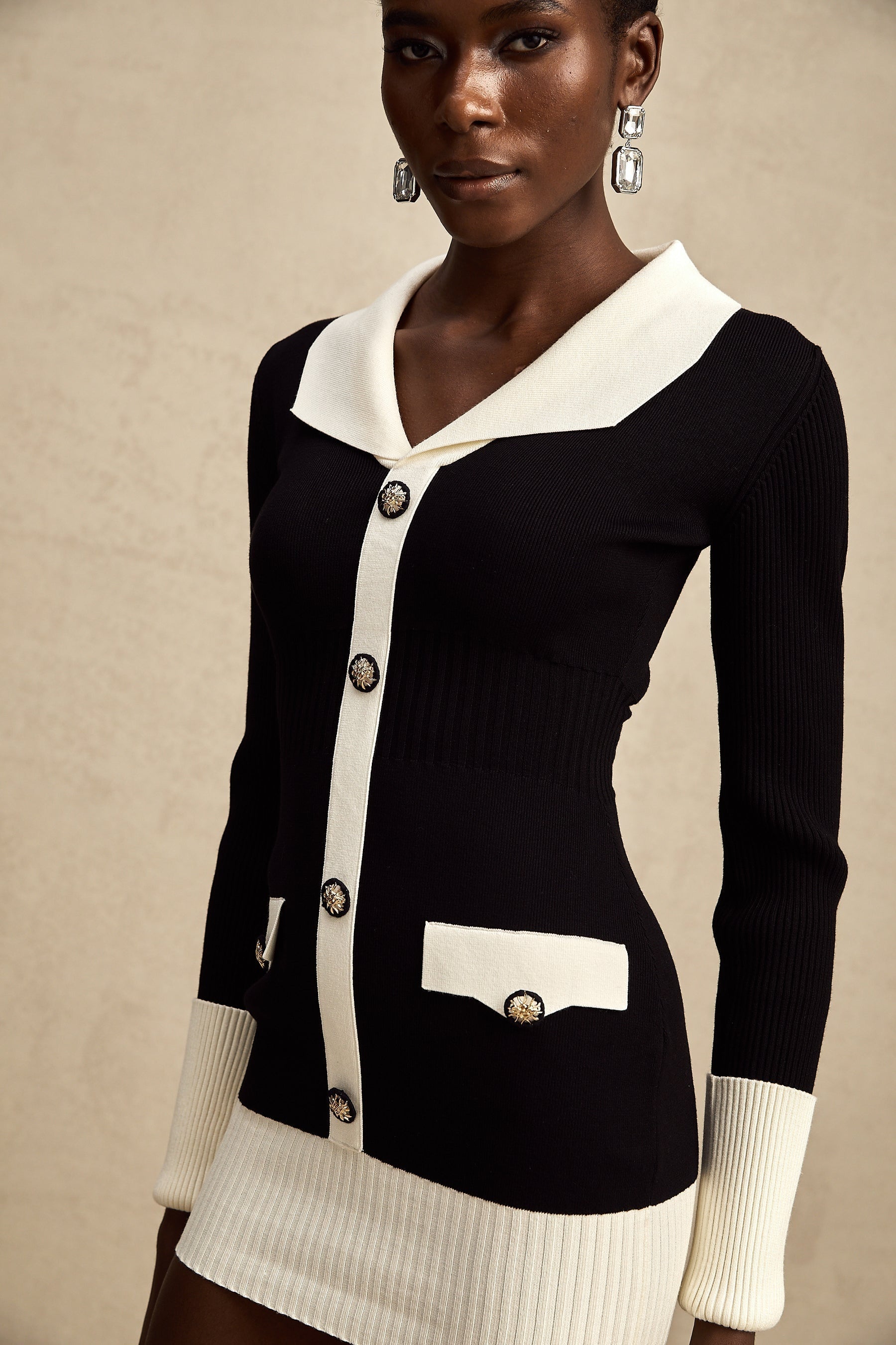A short wool dress with colorblocked design and ribbed knit texture featuring a mini length and a style named Charlotte
