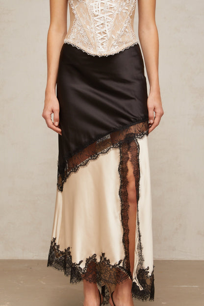 A sleek asymmetric satin skirt with delicate lace panel detailing named Raphaelle featuring a flowing silhouette and elegant design