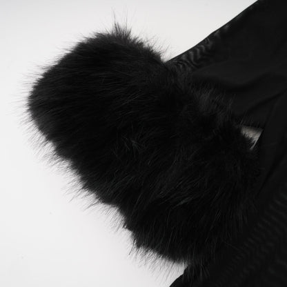 A sleeveless black top with a faux fur bodice and sheer tulle overlay creating a luxurious and elegant look