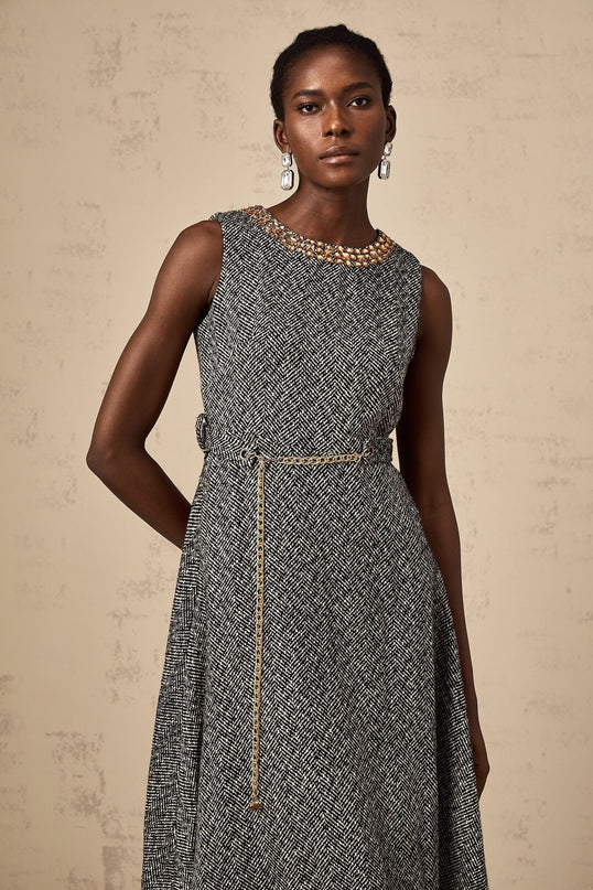 A sleeveless grey tweed midi dress with crystal embellishments for Valentines Day featuring a fitted silhouette and neutral color palette