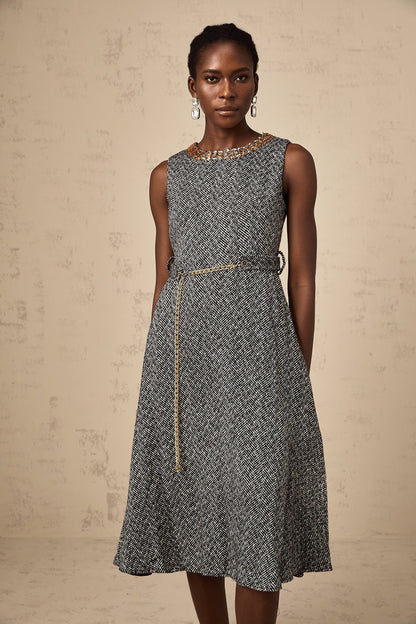 A sleeveless grey tweed midi dress with crystal embellishments suitable for Valentines Day featuring a fitted silhouette and textured fabric