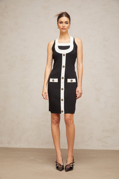 A sleeveless knit mini dress with a halter neckline featuring color blocks in different shades The dress has a form fitting silhouette and falls above the knee