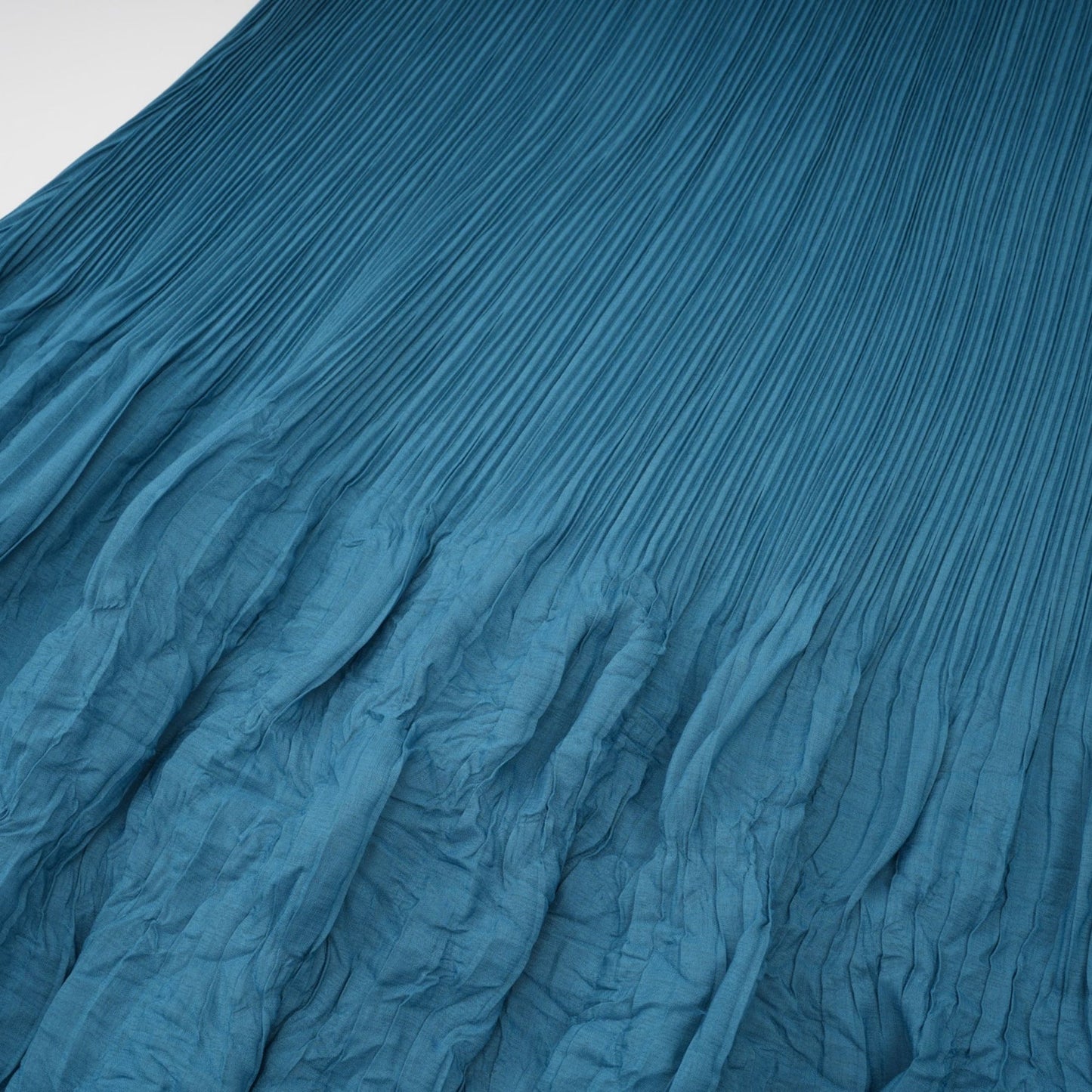 A sleeveless midi dress with a bubble design pattern featuring a fitted bodice and flowy skirt in a light feminine color