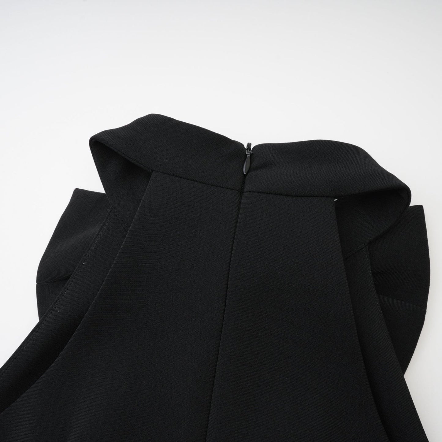 Black sleeveless dress with cutout design bowknot embellishment thigh length and rear zip fastening Made of 65% Viscose 35% Polyamide