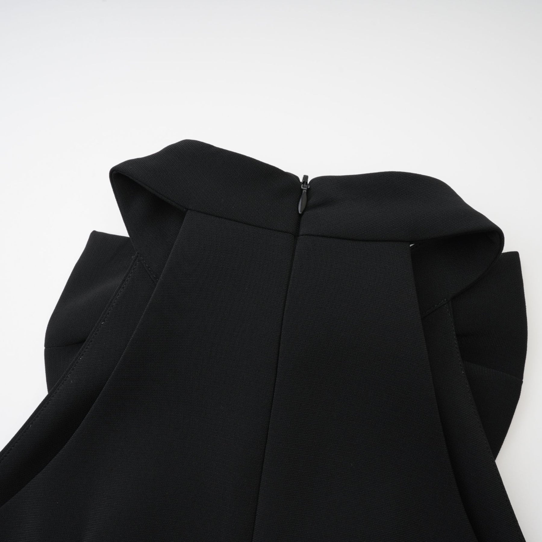 Black sleeveless dress with cutout design bowknot embellishment thigh length and rear zip fastening Made of 65% Viscose 35% Polyamide