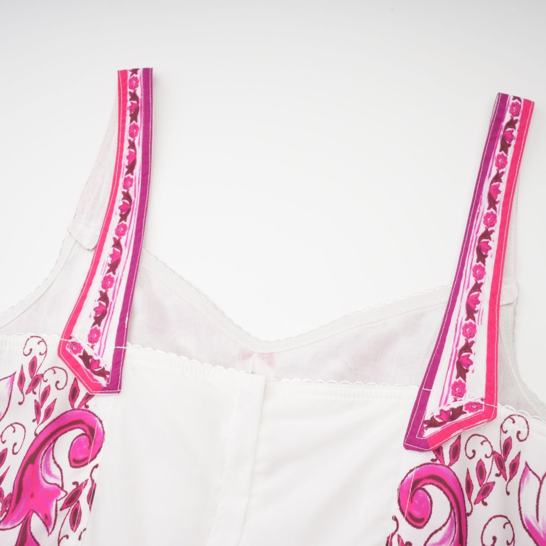 Pink sleeveless mini dress with sweetheart neck and allover graphic print styled with a flared skirt and zip fastening