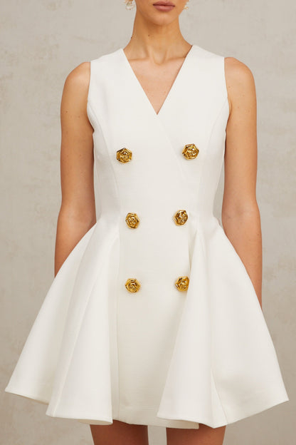 A sleeveless mini dress with a pleated peplum hem named Elise featuring a fitted silhouette and likely in a solid color