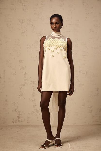 A sleeveless mini dress with faux flower details in a summery style
