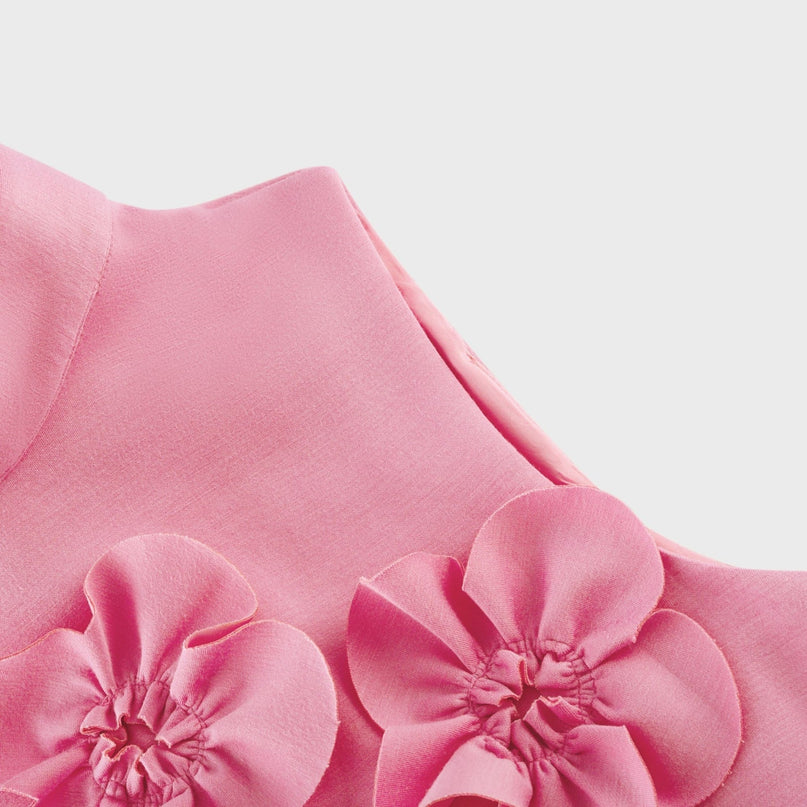 A sleeveless pink maxi dress with a bow and decorative artificial flowers called Magali
