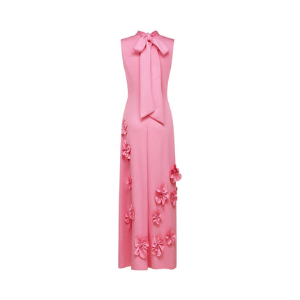 A sleeveless pink maxi dress with a bow and decorative artificial flowers named Magali