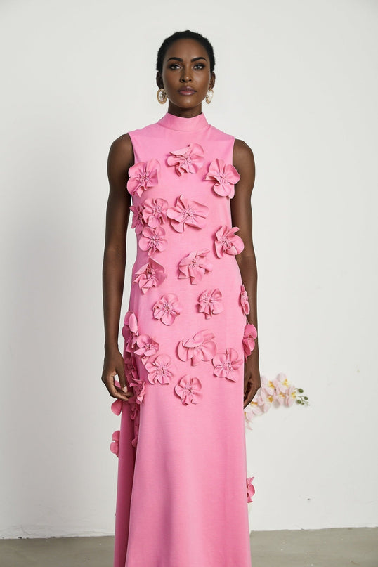A sleeveless pink maxi dress with a bow and decorative artificial flowers named Magali