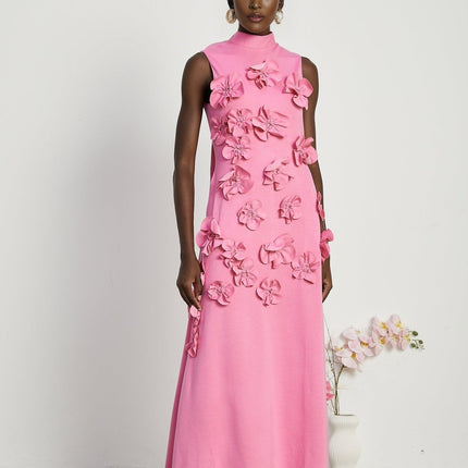 A sleeveless pink maxi dress with a bow and decorative artificial flowers named Magali