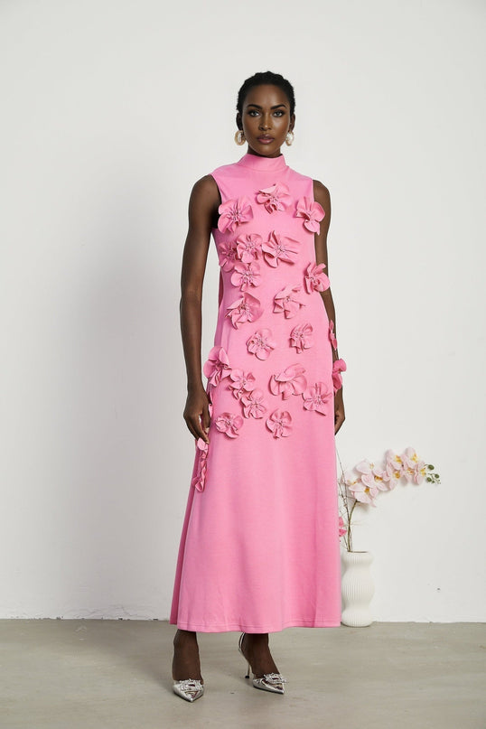 A sleeveless pink maxi dress with a bow and decorative artificial flowers named Magali