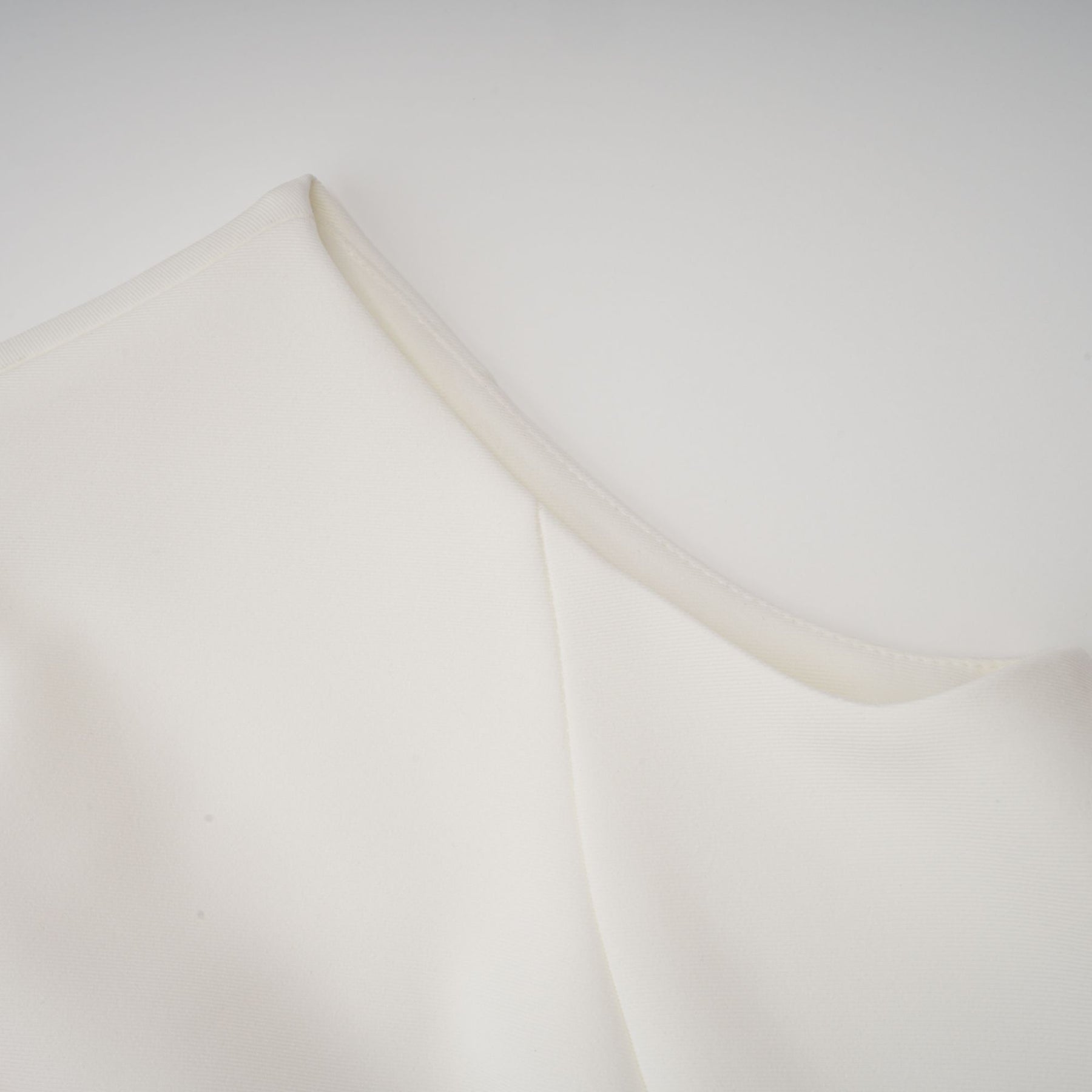 A sleeveless white midi dress with 3D petal details featuring a design by Veronique
