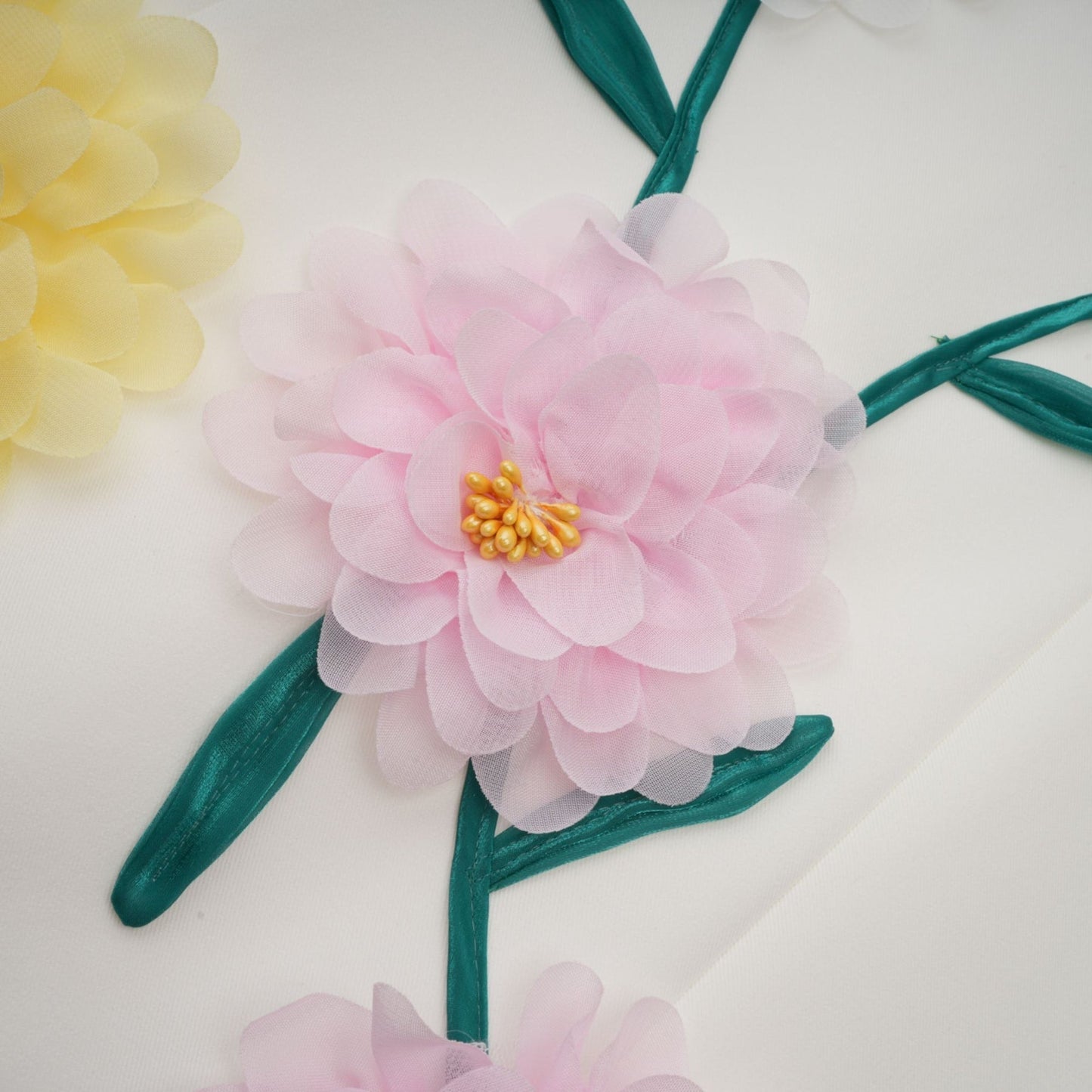 A sleeveless white midi dress with 3D petal details featuring a design by Veronique