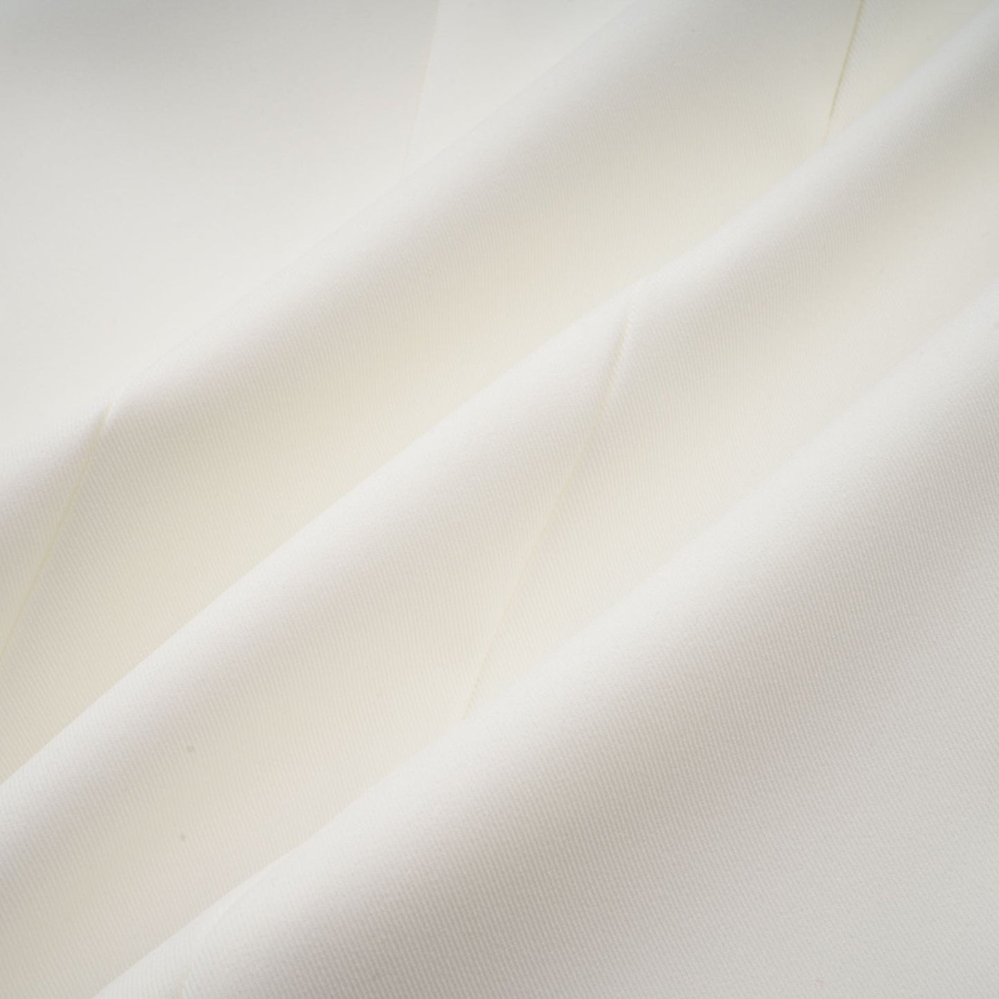 A sleeveless white midi dress with three dimensional floral petal details on the fabric