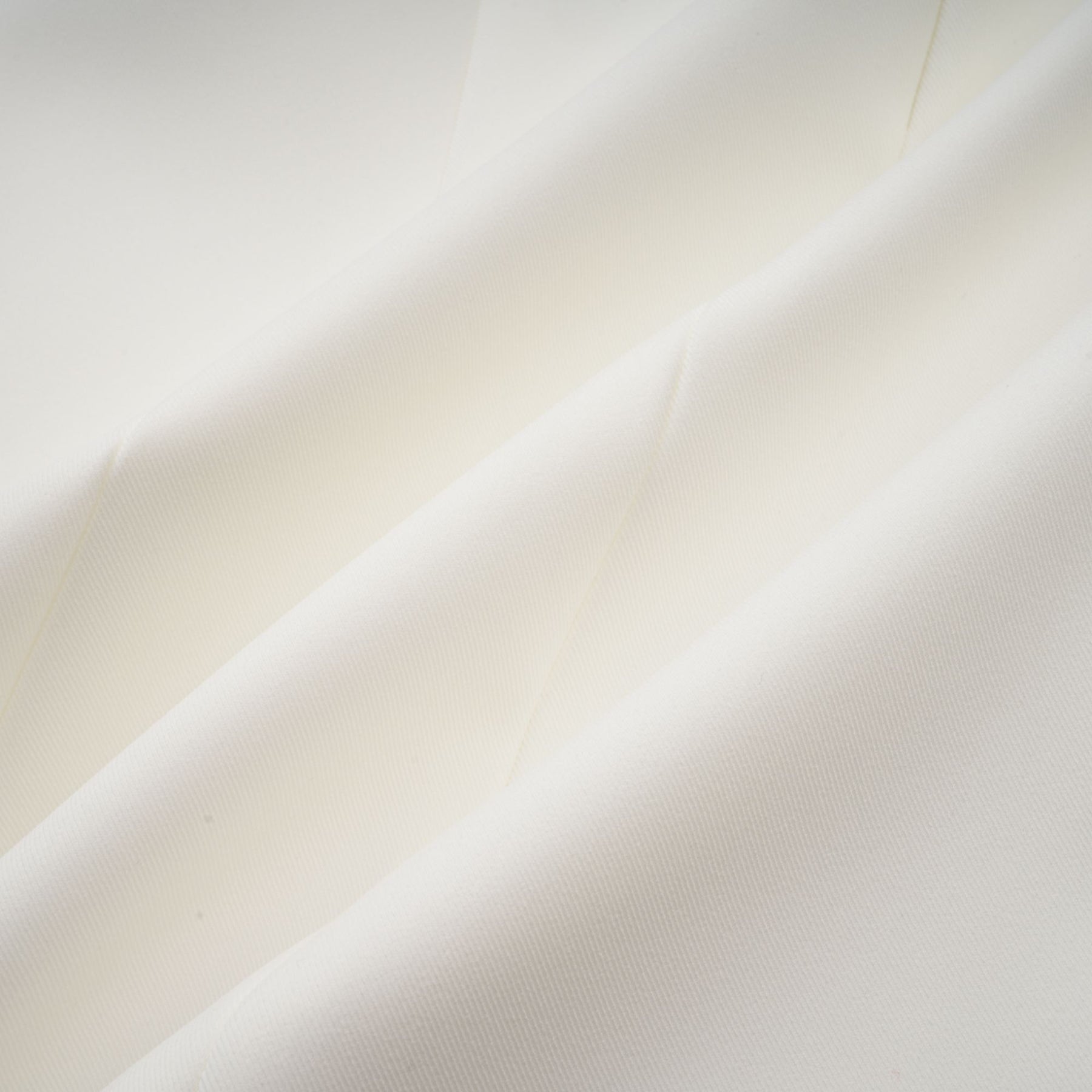 A sleeveless white midi dress with three dimensional floral petal details on the fabric