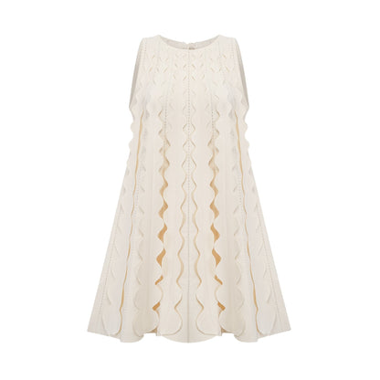 A sleeveless white mini dress with wavy details and a fitted silhouette named Axelle