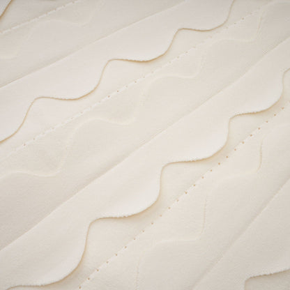 A sleeveless white mini dress with wavy details modeled on a female figure against a plain background