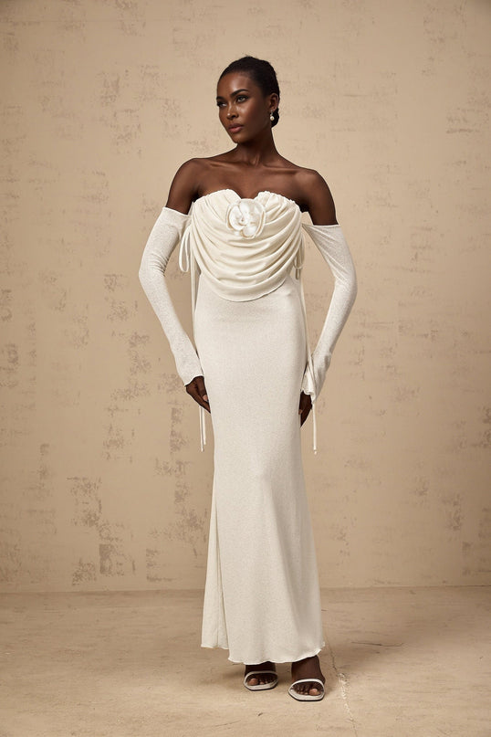 A strapless maxi dress with floral applique and ruched detailing in a vibrant pattern