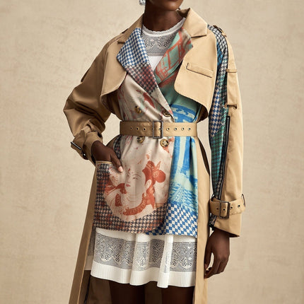 A stylish trench coat featuring contrasting color details and a printed design with a belt cinching the waist The coat is named Josephine and combines classic trench elements with modern flair