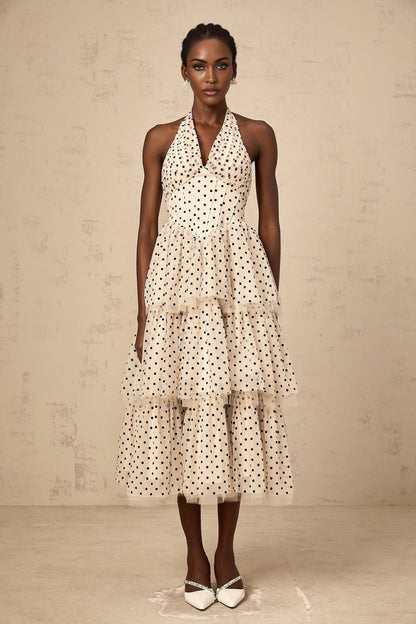 A tiered midi dress in ivory color with polka dot pattern named Philae featuring multiple layers in the skirt