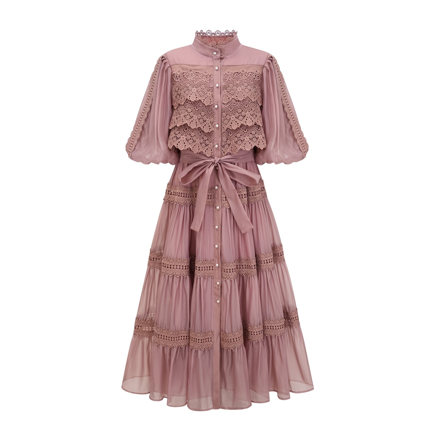 A tiered midi dress with lace cutouts featuring a light and airy design in white or cream color with intricate patterns and a flowy silhouette