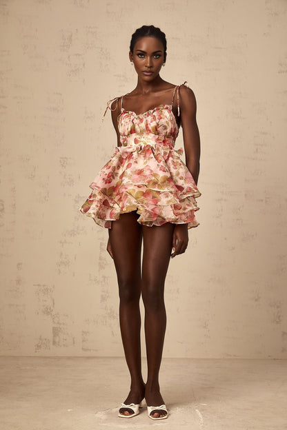 A tiered mini dress with a strawberry print pattern featuring a design inspired by Angele