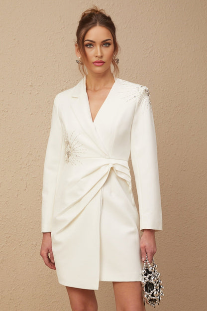 A white asymmetric blazer dress with embellishments featuring a fitted silhouette and unique design elements named Mireille