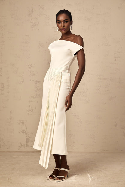 A white asymmetric midi dress with draped fabric details worn by a model standing against a plain background