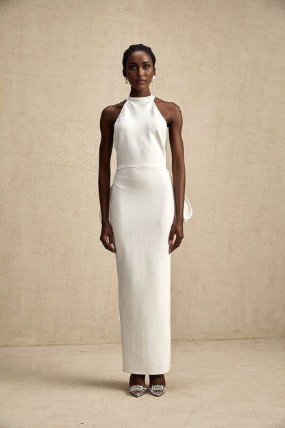 A white bandage dress with an oversized bow detail featuring a fitted silhouette and Capucine style design