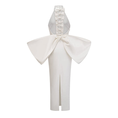 A white bandage dress with an oversized bow detail named Capucine featuring a formfitting silhouette and elegant design