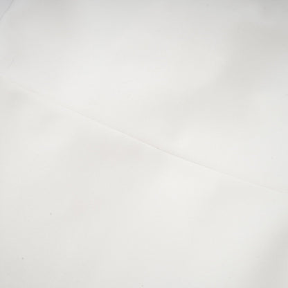 A white bandage dress with an oversized bow detail named Capucine featuring a formfitting silhouette and exaggerated bow accent
