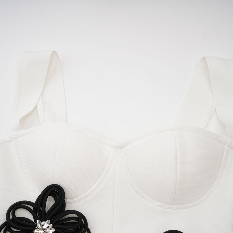 A white bandage maxi dress with floral appliqué details named Olivia