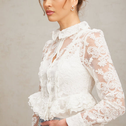 A white blouse with delicate floral embroidery and lace details named Karine
