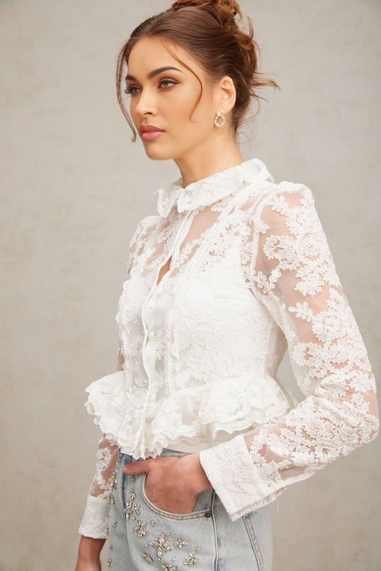 A white blouse with delicate floral embroidery and lace details named Karine