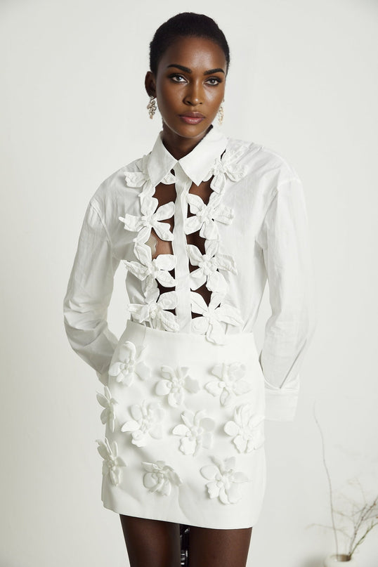 A white blouse with floral pattern and cutout details named Rosalie